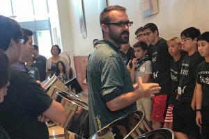 singhaus teaching children to play the drum