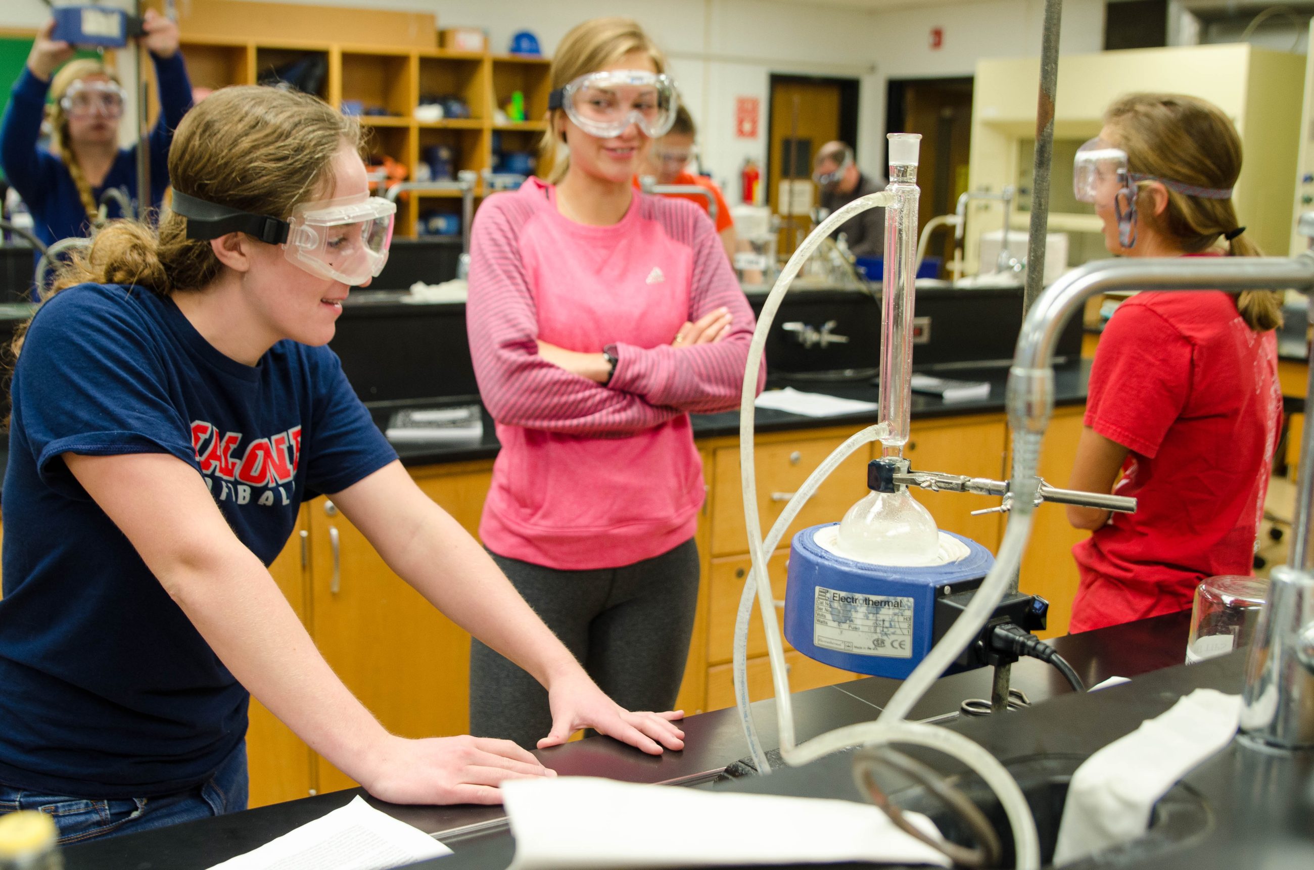 several students wearing goggles in a science laboratory
