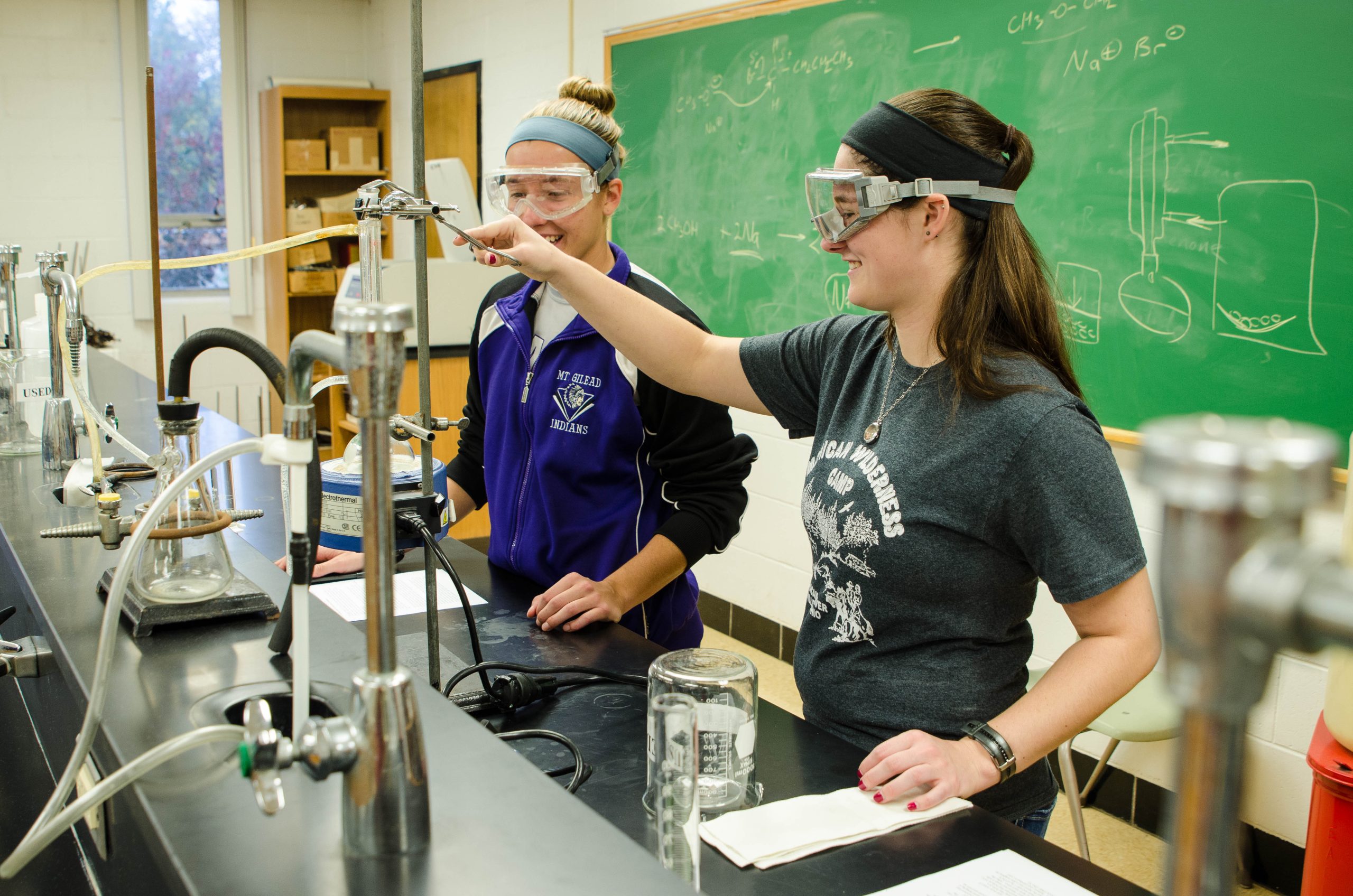 2 female students in chemistry lab