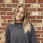 Ellie Stevenson in front of brick wall
