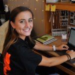 Selah Lau seated in front of laptop computer
