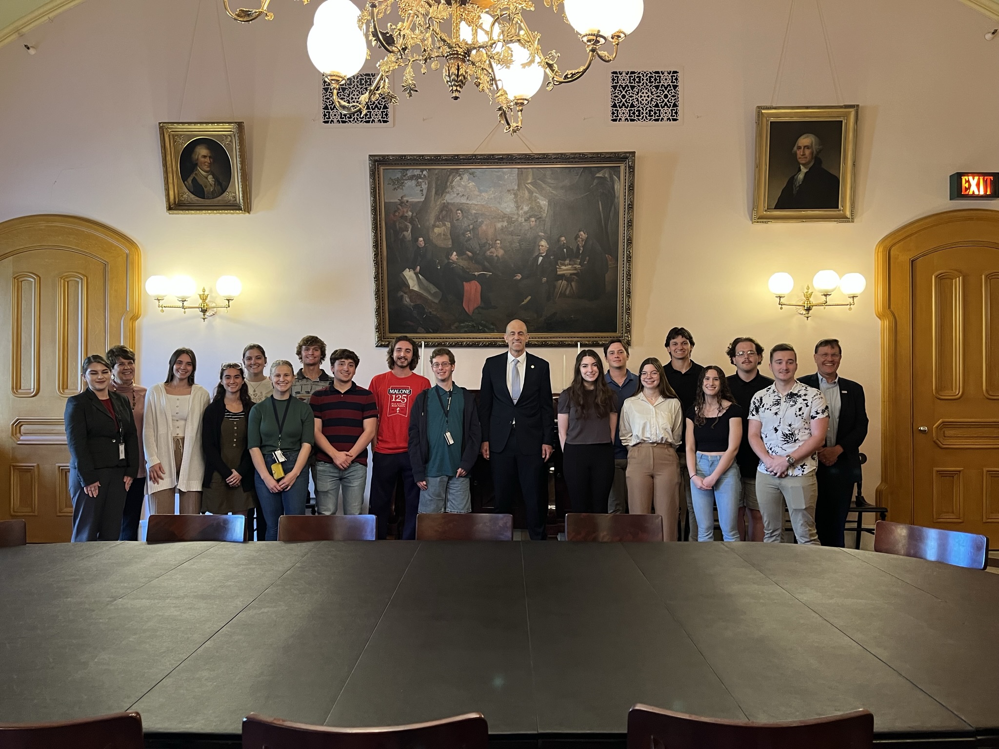 Drs. Scott Waalkes and Jacci Stuckey pictured wth student group and Ohio House Rep. (district 49), Jim Thomas, in large room in the Ohio Statehouse; alumna, Emma Martinez on far left.