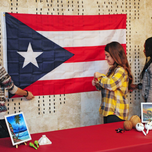 students in front of flag display related to Spanish for Service and the Professions minor