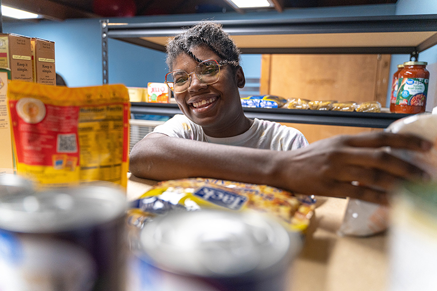 female student working to organize non-perishable food donations
