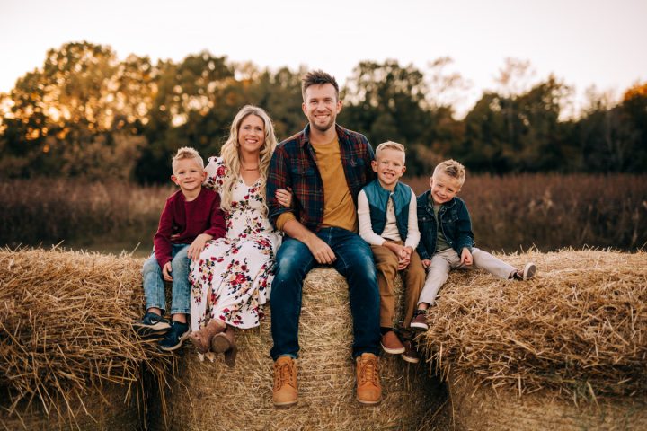 Jim Jacob and family posed in front of a scenic country background