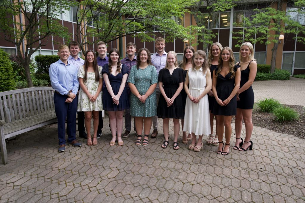 2024 Malone Bachelor of Science in Nursing graduates standing together in the Johnson Center courtyard.