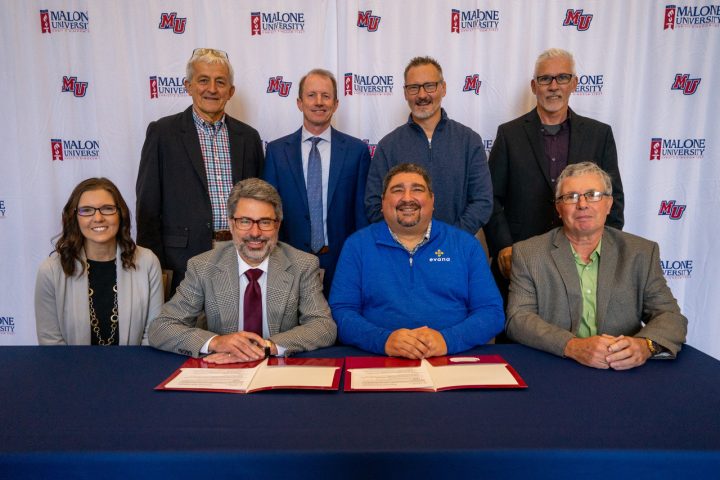 Malone President Gregory J. Miller and Evana Network representatives group shot