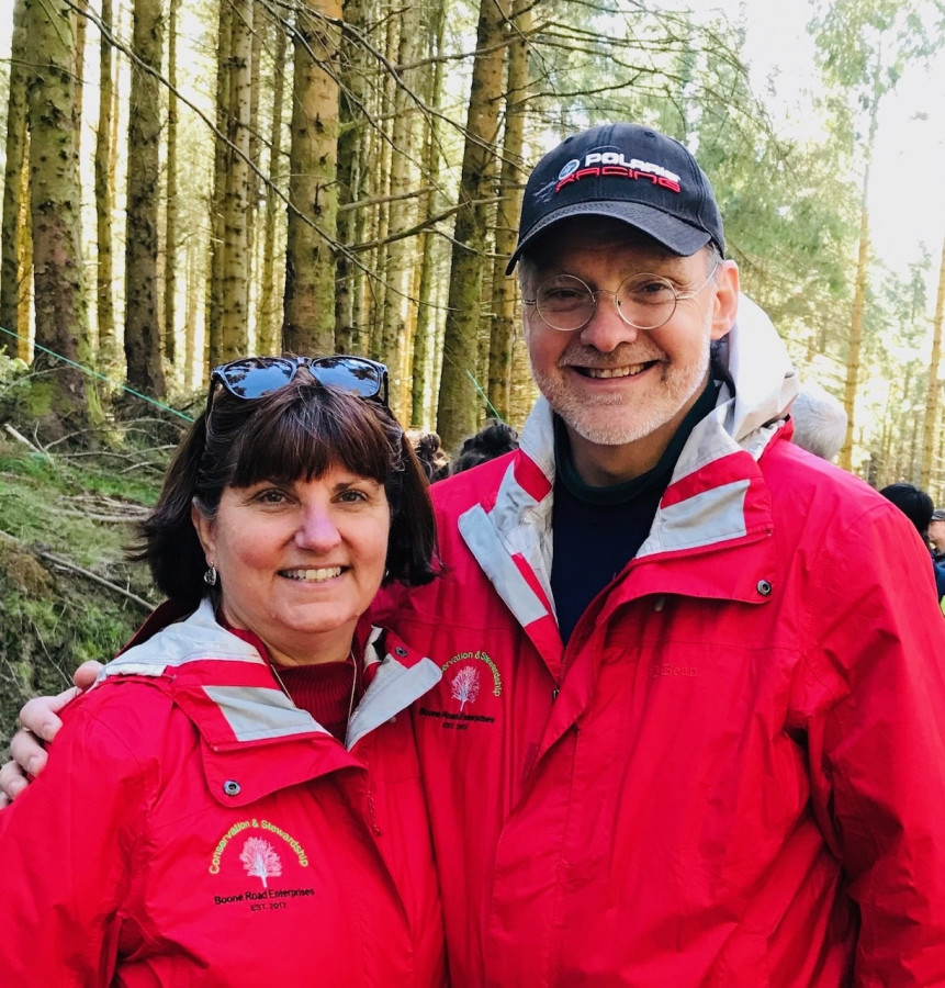 Jim and Heidi Gresh posing in front of timberland
