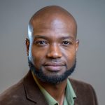 Headshot of Andre Payne smiling at camera