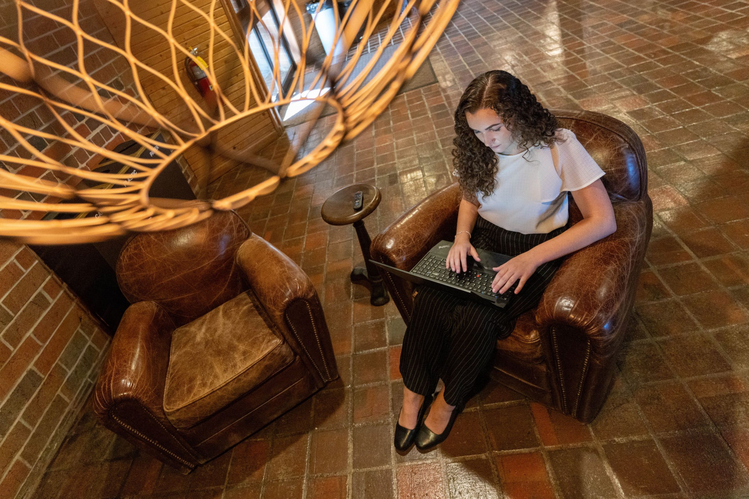female student working on lap top in student lounge