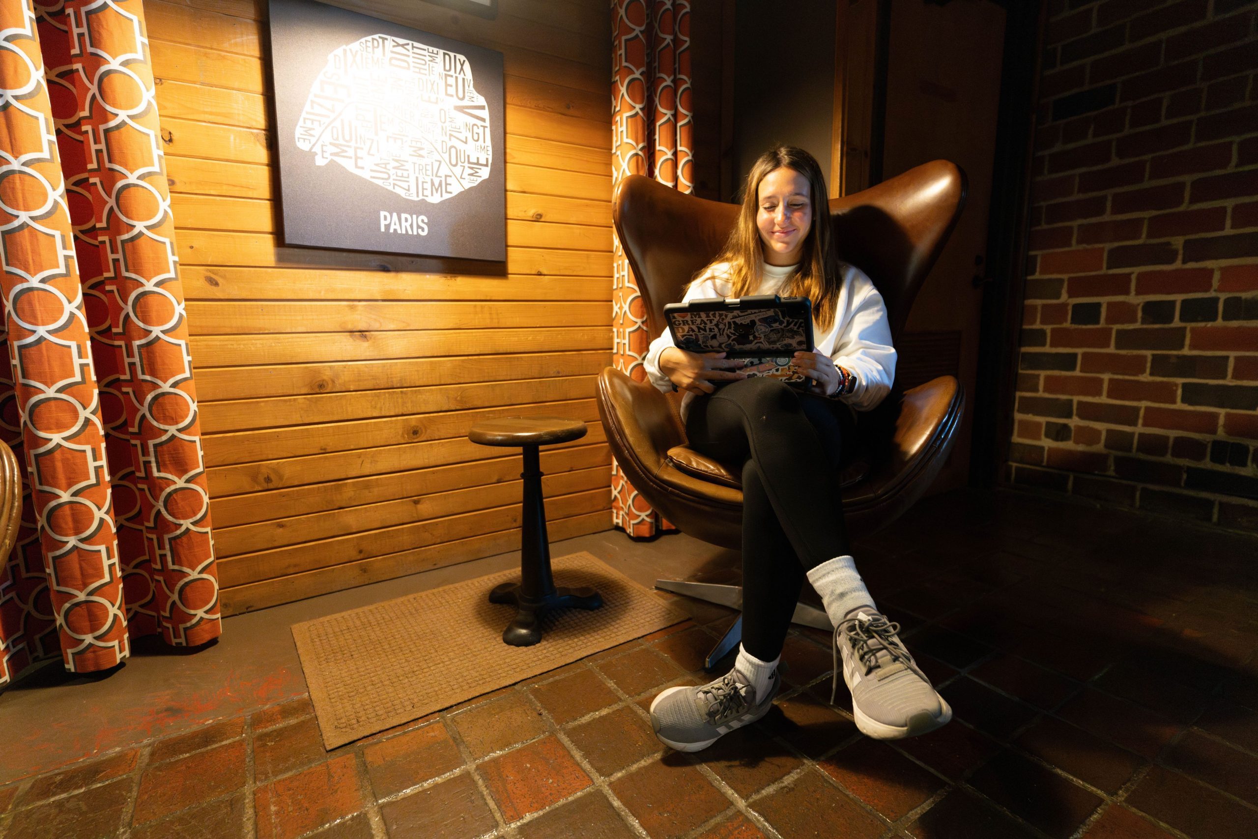 student sitting in a chair working on her lap top