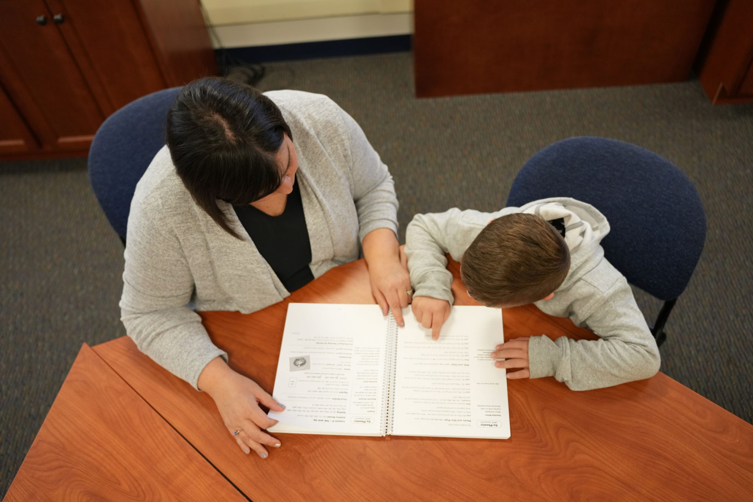 woman helping a student with schoolwork