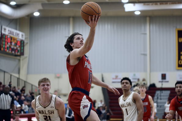 Male Malone student athlete goes in for a basketball layup