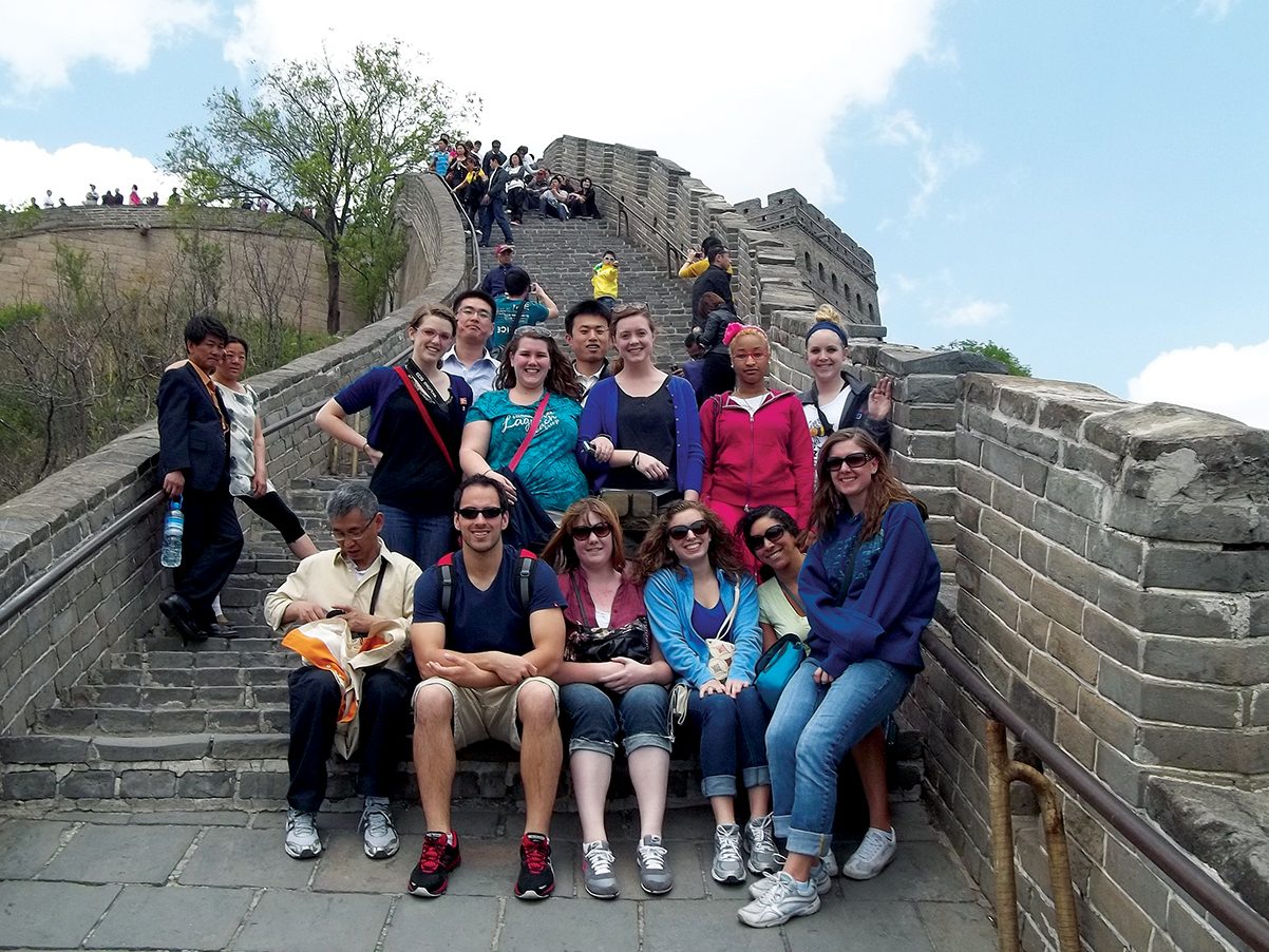 group of students and tourists seated on steps