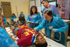 Nursing students working on patient
