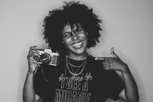Audra Edwards holding camera and smiling brightly