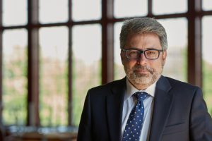 Greg Miller in front of windows